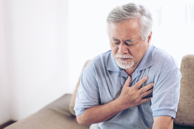 senior male asian suffering from bad pain in his chest heart attack at home senior heart disease