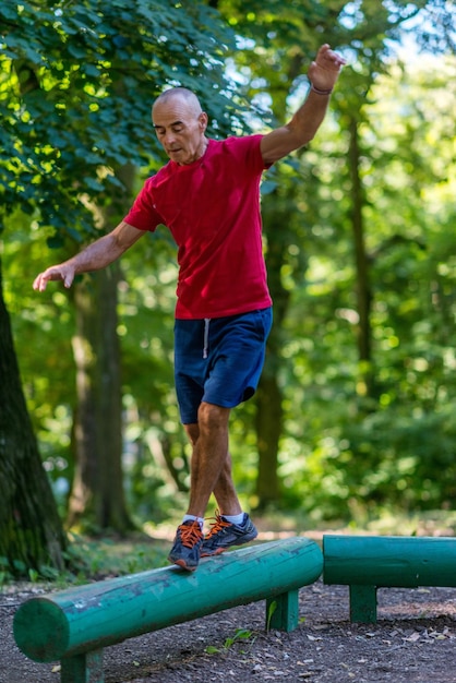 senior male exercising outdoors in public park