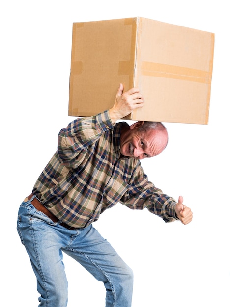 Senior man carries a heavy box