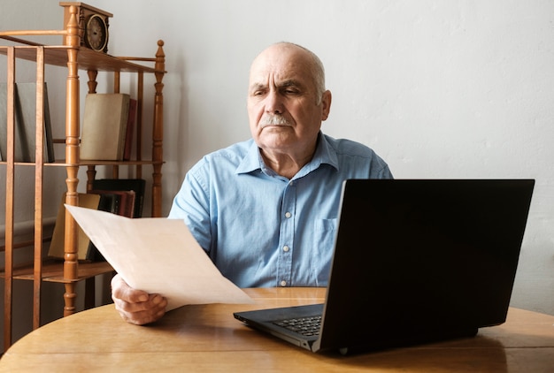 Senior man checking a handheld document