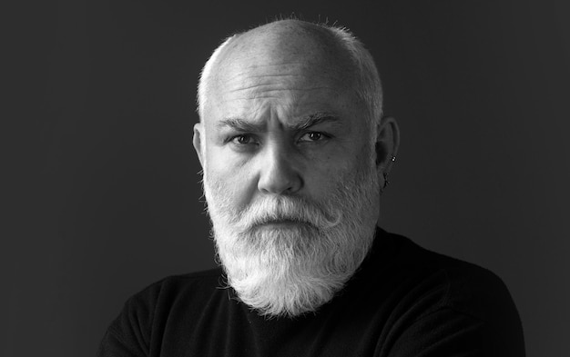 Senior man close up portrait of an elegant senior man with grey hair isolated on black background