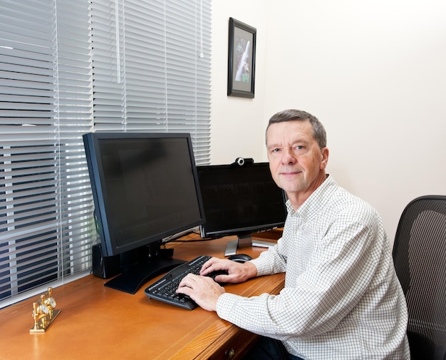 Senior man at computer desk