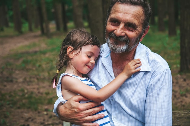 Foto senior man die zijn kleine kleindochter vasthoudt