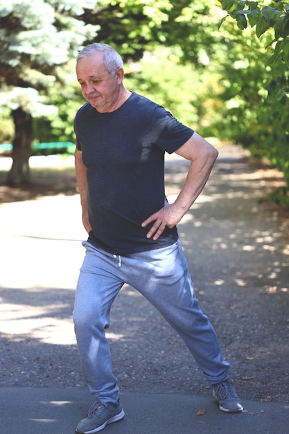 Senior man doing exercises on the street