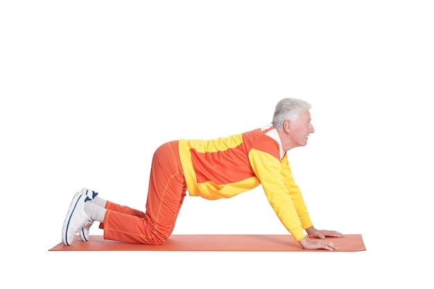 Senior man exercising on a white background