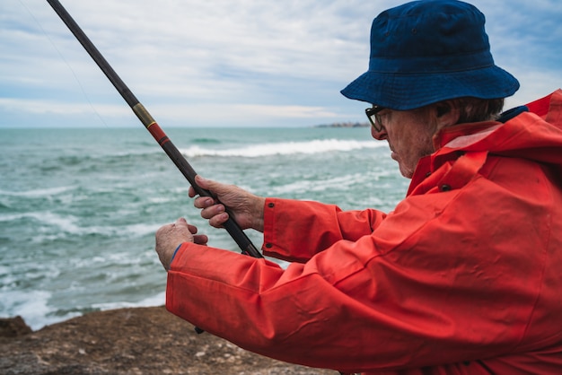 Senior man fishing in the sea.