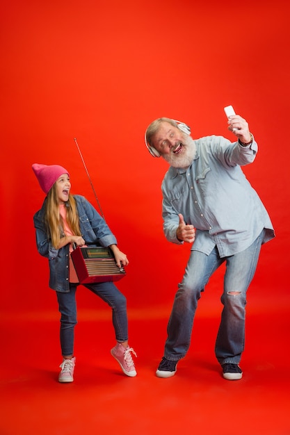 Senior man, grandfather having fun and spending time together with girl, granddaughter.