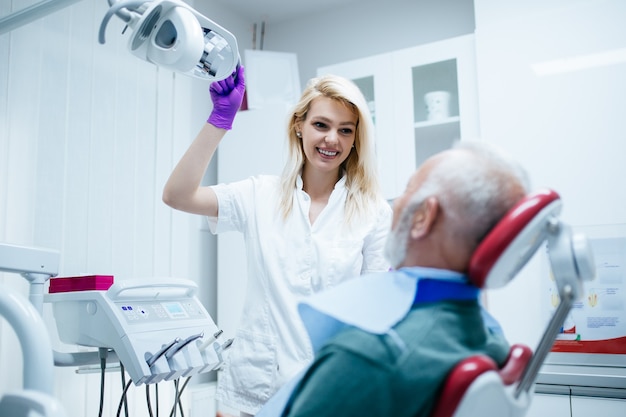 Senior man having dental treatment at dentist's office.