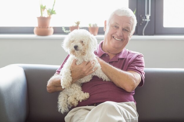 Senior man holding a dog