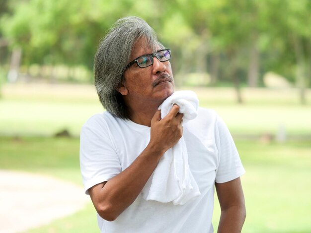 Senior man holding napkin at park