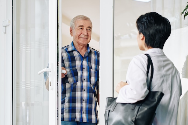 Senior man inviting caregiver