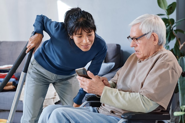 Senior man learning to use mobile phone