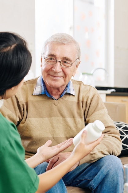 Senior man listening to nurse talking