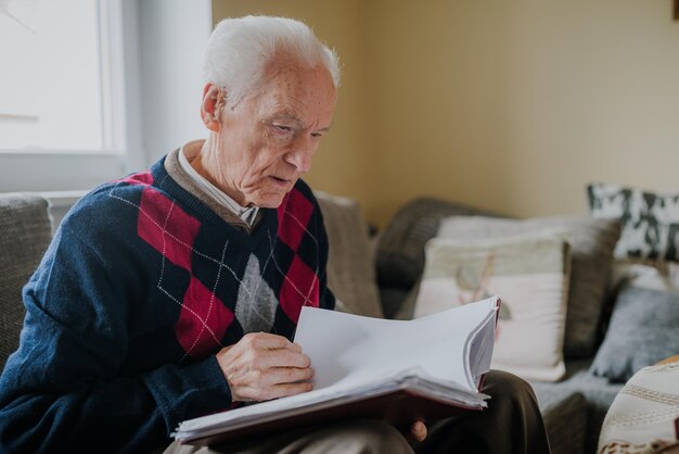 Senior man reading book at home