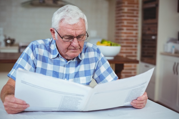 Senior man reading newspaper