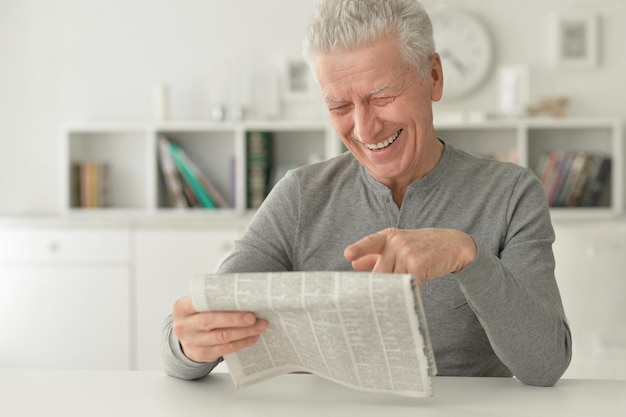 Senior man reading newspaper