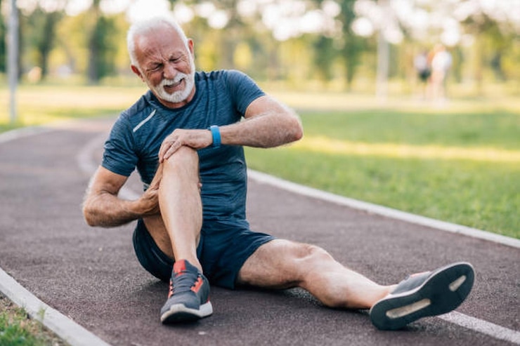 Photo senior man runner with knee pain in the park