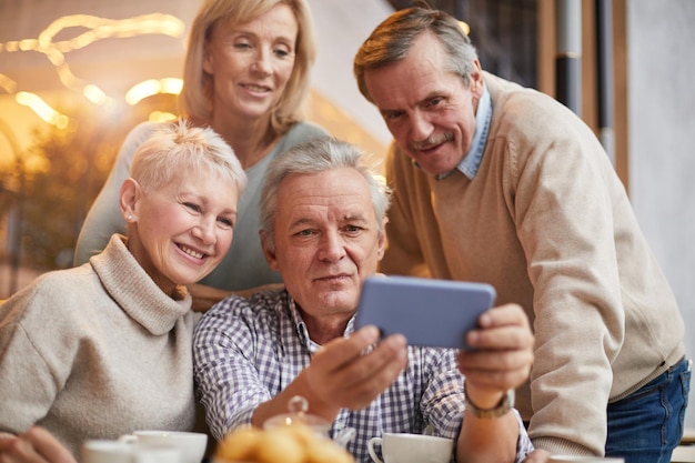 Senior man sharing video with friends