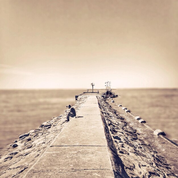 Senior man sitting at jetty