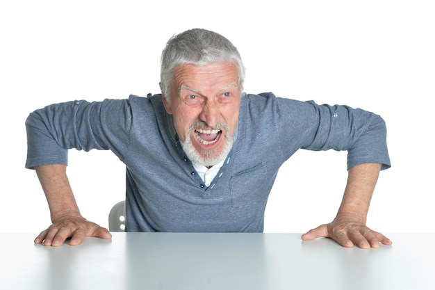 Senior man sitting at table