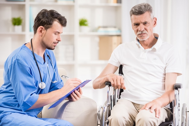 Senior man sitting in wheelchair at doctor's office.