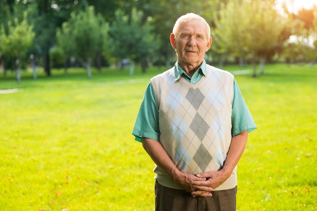 Senior man standing outdoors.