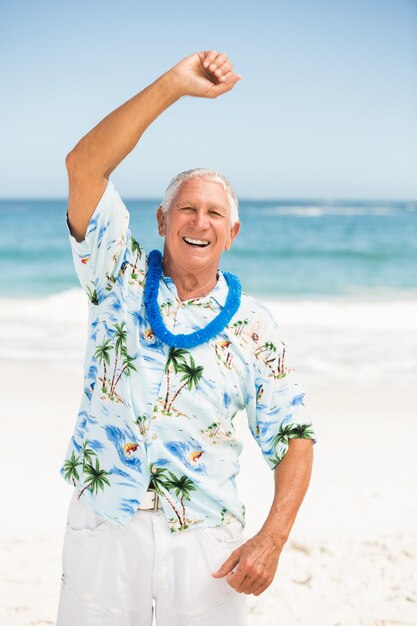 Senior man stretching at the beach