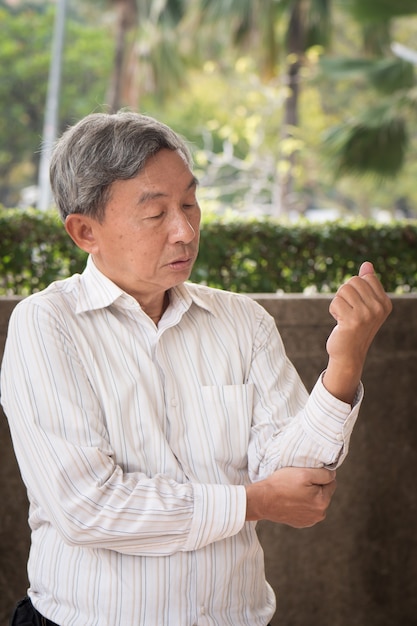 Senior man suffering from elbow joint pain