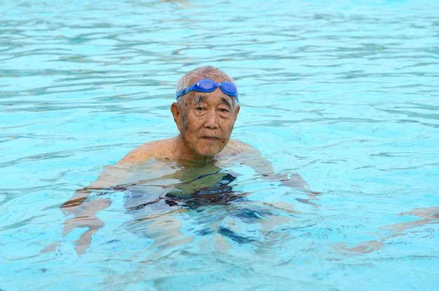 Senior man swimming in pool