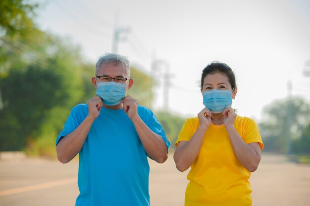 Senior man then Senior women wear face mask to protect coronavirus covid19