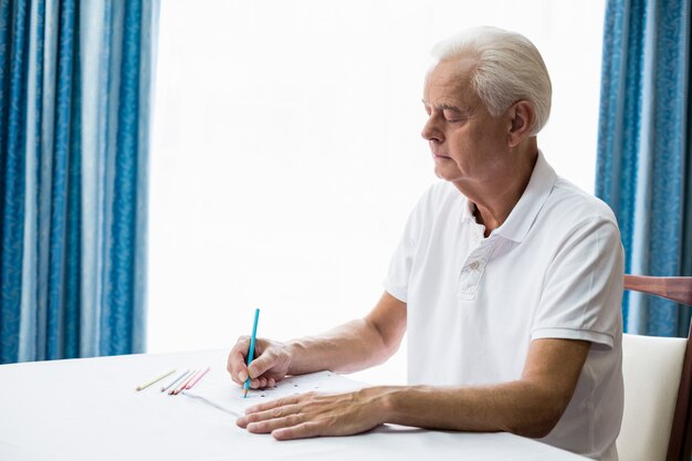 Senior man using a colouring book