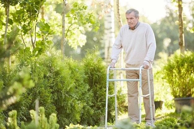 Senior Man Using Walker in Park