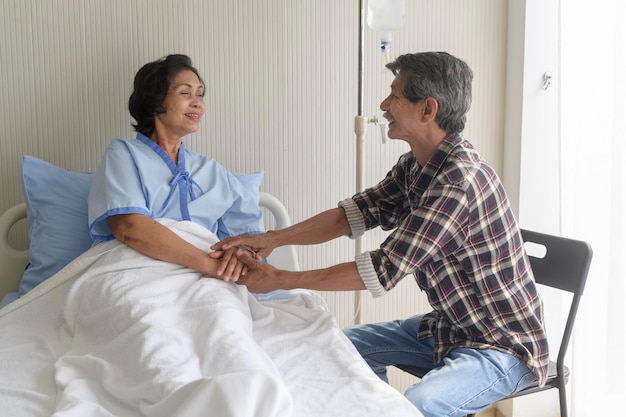 A Senior man visiting senior patient woman at hospital health care and medical concept