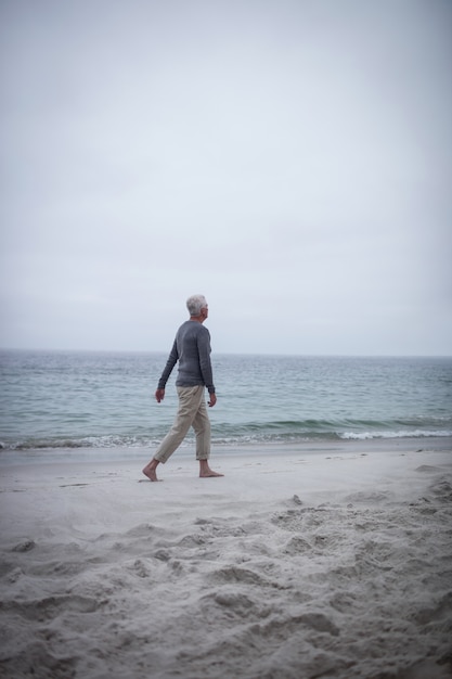 Senior man walking on the beach