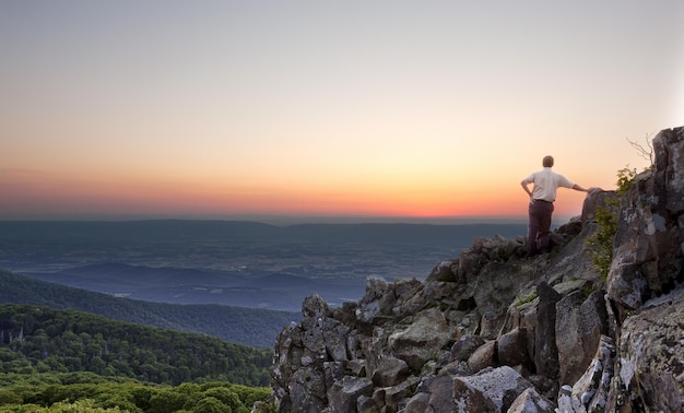 Senior man watches sunrise over blue ridge