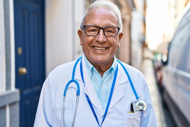Senior man wearing doctor uniform standing at street