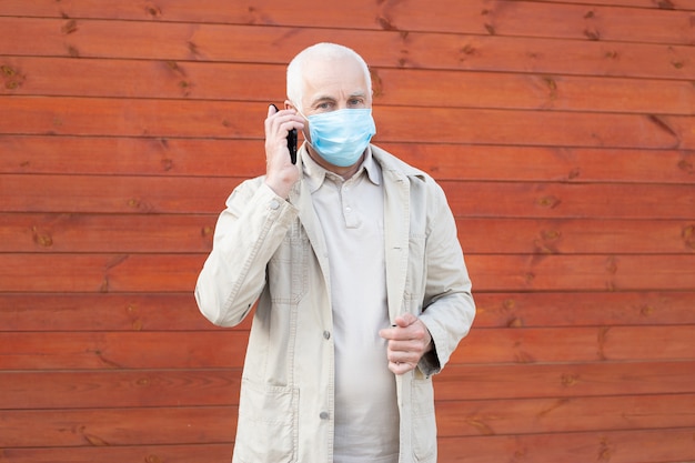 Senior man wearing medical mask protect himself from coronavirus, medical and health concept