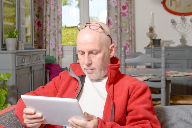 A senior man with a digital tablet