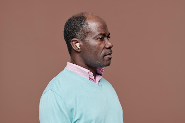 Senior man with hearing aid in ear