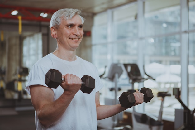 Senior man working out at the gym