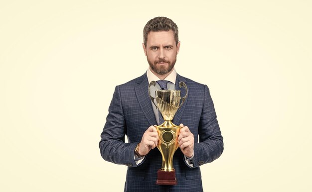 Photo senior manager in formal suit hold golden cup for business success isolated on white trophy