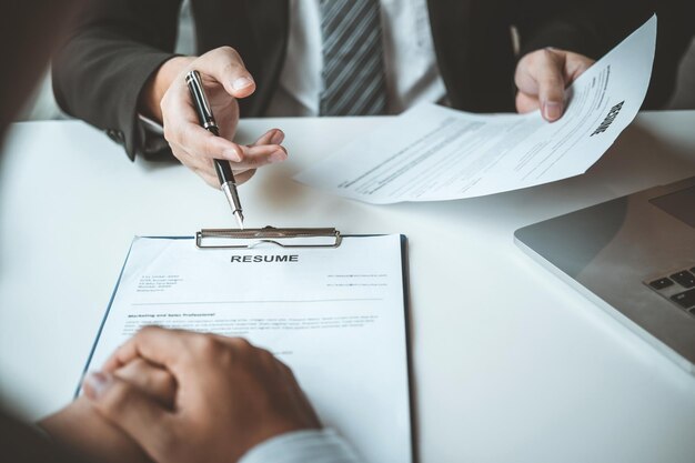 Senior manager HR reading a resume during a job interview employee young man meeting Applicant and recruitment