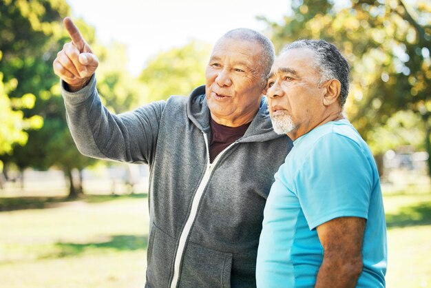 Senior men park discussion and outdoor view with fitness training and wellness with friends Nature workout and conversation with exercise retirement and communication of elderly people together