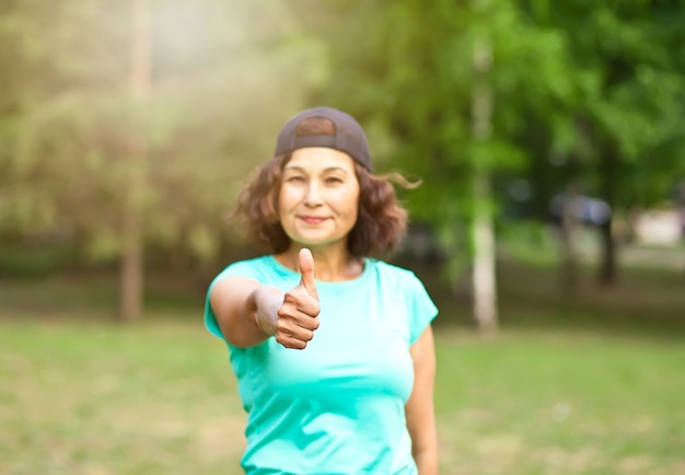 Senior middle age female woman running outdoors in a park