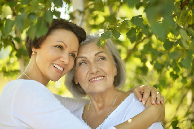 Senior Mother and her nice daughter in  park