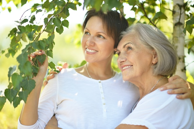 Senior Mother and her nice daughter in  park