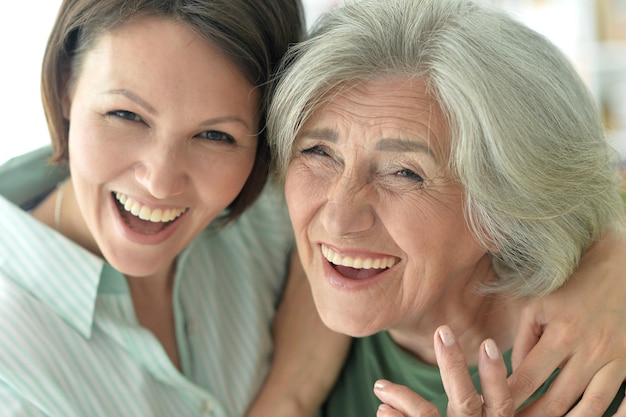 Senior mother with adult daughter, posing together