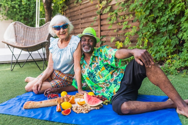 Senior multiethnic couple at picnic outdoors