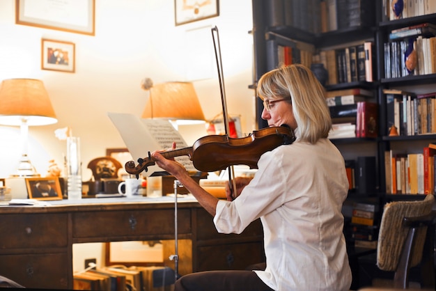 Senior musician playing on a violin