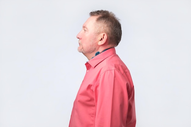 Senior old man in red shirt from profile view